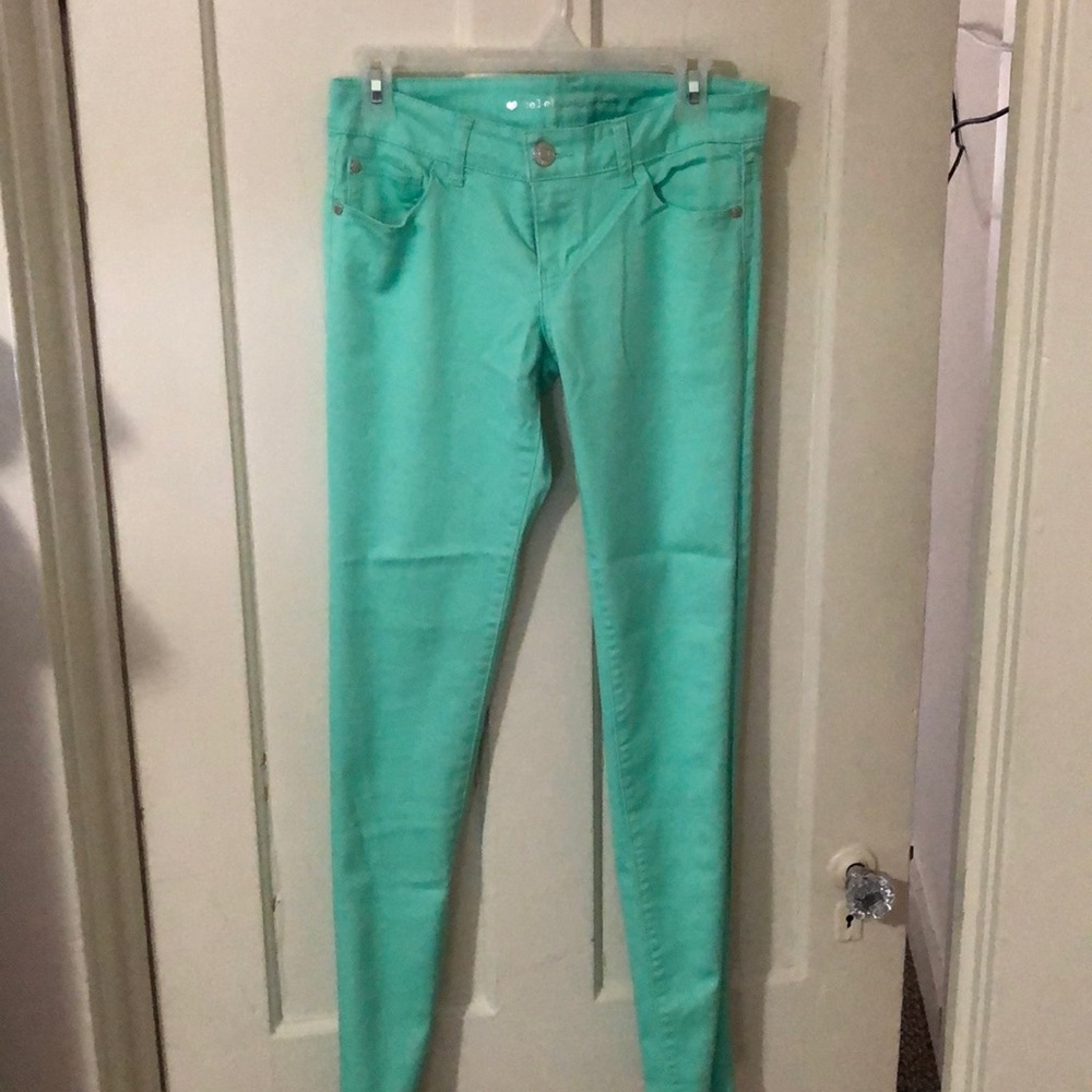 Aqua colored skinny jeans.